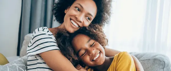 Mother hugging her daughter.